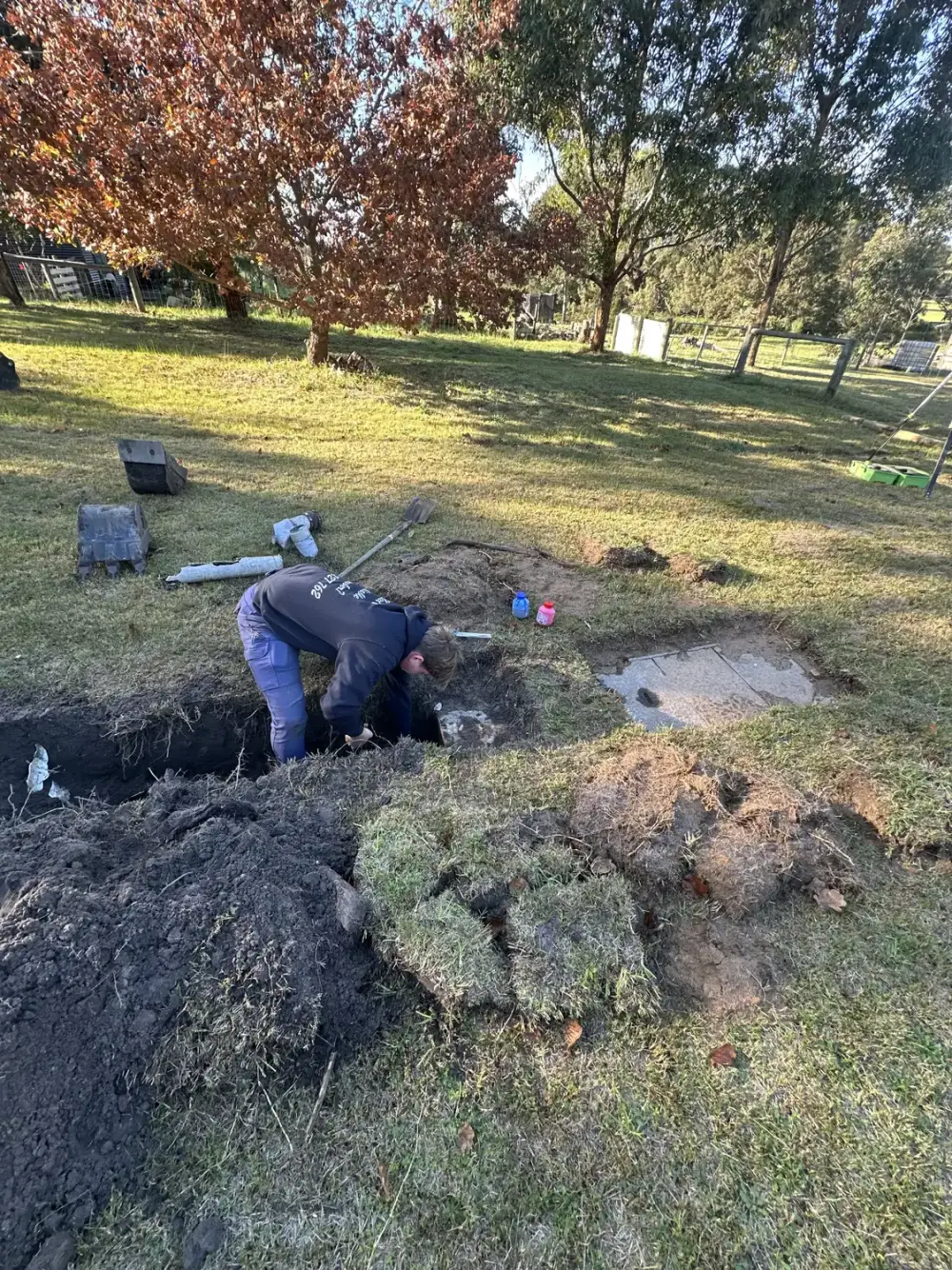 Riviera Plumbing locating and digging to a septic tank lid on a rural East Gippsland property